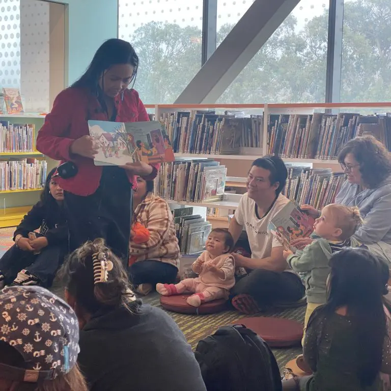 Justine Villanueva (Sawaga River Press) reads her book to a group of children and parents at the South San Francisco library